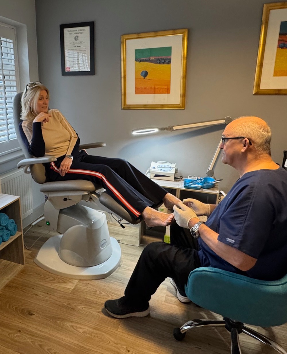 A Photograph of Clive in his Clinic with a client receiving treatment